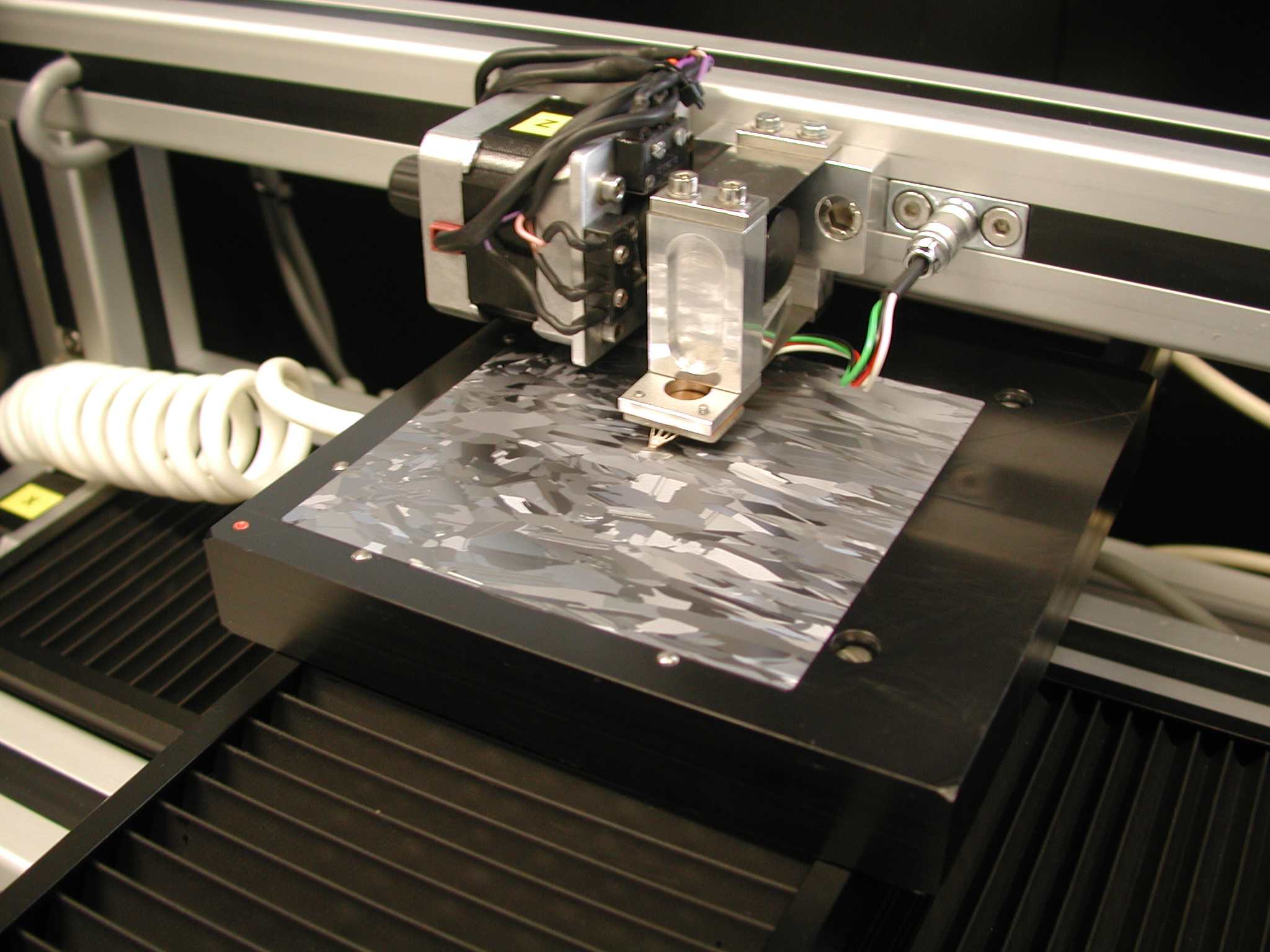 A square wafer being measured in the surface resistance scanner